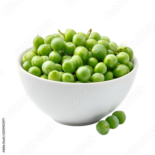 Fresh green peas spilling from white ceramic bowl on bright background