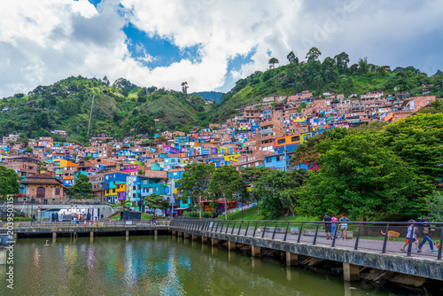 Colombia, Medellin, Comuna 3, Manrique, water reservoir and colourful painted houses built on a slope.
