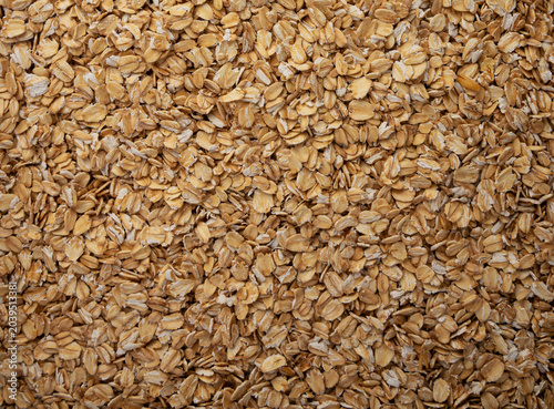 Oat flakes textured pattern, rolled oatmeal macro background