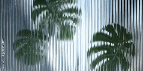 Obraz na płótnie Green monstera leaves viewed through vertical ribbed glass texture with monstera