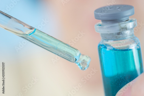фотографія dropper with copper peptide serum ghk cu macro pipette glass vial liquid blue fl