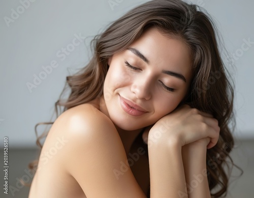 A woman hugs herself by the shoulders. Self-care.