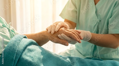 Healthcare professional offering compassionate support and gentle comfort to an elderly patient, emphasizing the invaluable human connection in medical care and wellbeing