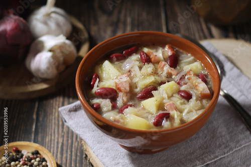 A bowl with traditional Slovenian soup Jota in rustic style