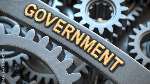 A close-up view of interlocking gears with the word GOVERNMENT on one gear