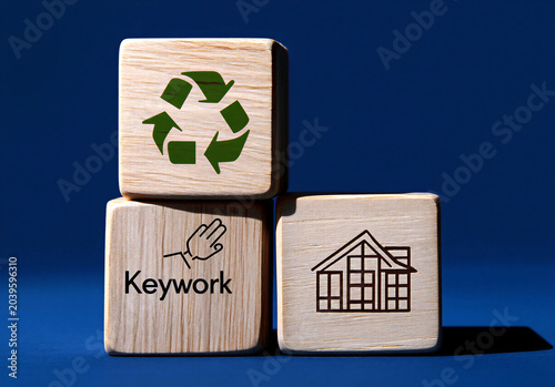 Wooden blocks with recycling home and keyword icons on blue background