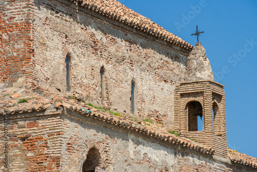Small brick belfry with a cross stands on the Uplistsikhe Church near Gori