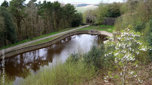 People relaxing at Rivington terraced gardens in spring, high angle view of famous English heritage site in Greater Manchester.
