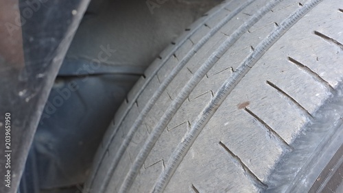 Photos Worn tire tread showing impaled nail puncture