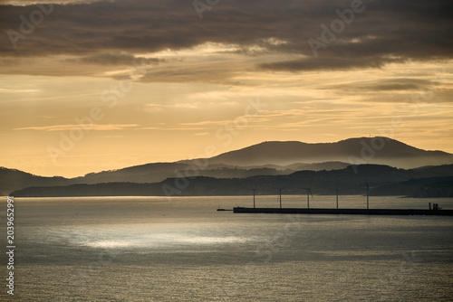 Wind turbines generating clean energy at sunrise