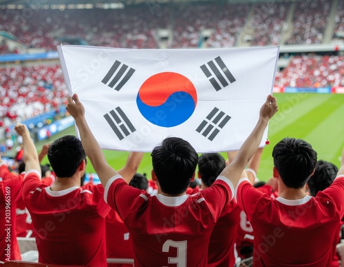 Dynamic medium shot of South Korea national team fans (Red Devils), wearing red jersey