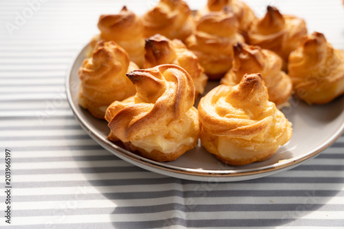Tableau sur toile freshly baked homemade profiteroles on the table