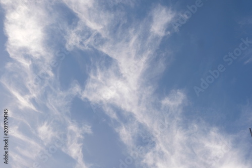 Wispy White Cirrus Clouds Against Clear Blue Sky