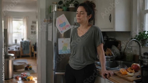 Overwhelmed Mother Seeks a Moment of Calm in a Cluttered Home Kitchen