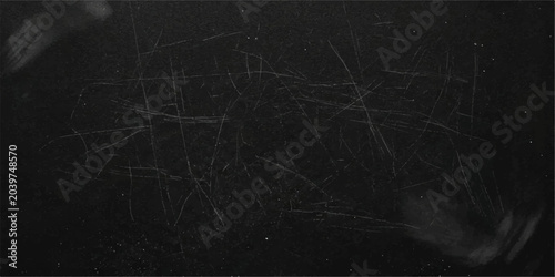 Foto A dark, scratched surface texture resembling a chalkboard or slate, hinting at erased writing or ancient markings