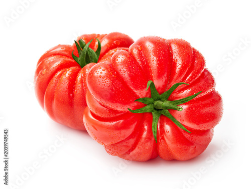 Fresh ribbed heirloom tomatoes with water droplets isolated