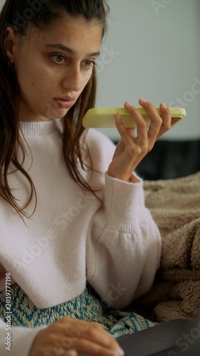 Remote nutritionist prepping lemon wellness shot on laptop