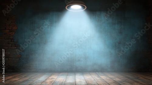 A spotlight illuminates a vacant room with aged brick walls and wooden floors