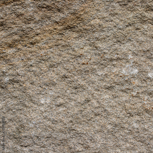 Natural brown stone surface background texture of old weathered rough wild rock wall