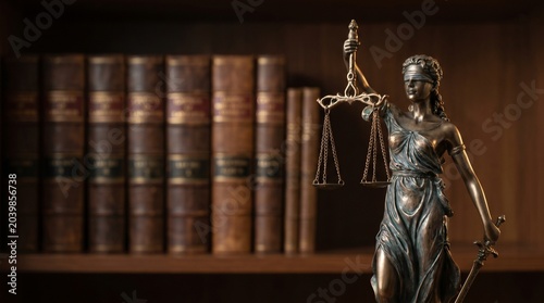 Bronze Lady Justice Statue With Vintage Law Books In Attorney Office