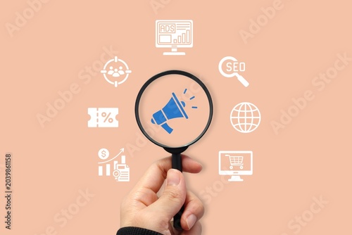Quadro su tela Digital marketing concept with magnifying glass highlighting megaphone icon surr