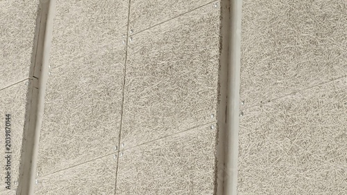Close-up of a textured concrete surface with subtle lines and variations, showcasing its rough and durable nature.