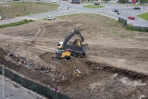 High Angle View of Excavator Loading Dumper Truck