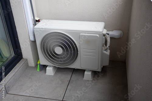 Outdoor Air Conditioner Compressor Unit Installed on Balcony Floor