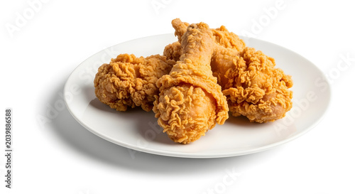 Crispy fried chicken drumsticks and pieces served on a white ceramic plate isolated on a white background.