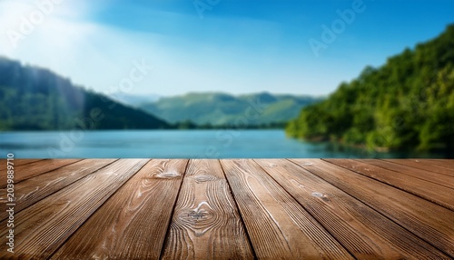 Empty Wooden Boards Weathered Planks Table Top With Blur Background Of Landscape With Lake Or Bay And Mountains At Sunny Summer Day