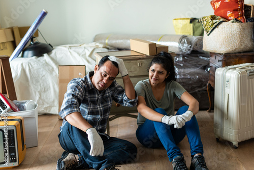 Photography Tired couple amidst moving boxes