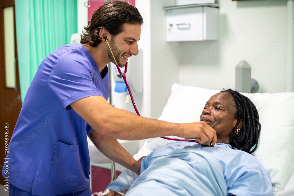 Fototapeta premium Doctor caring for hospital patient.
