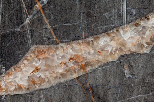 Cristal white golden vein of a dark gray marble close up background texture material