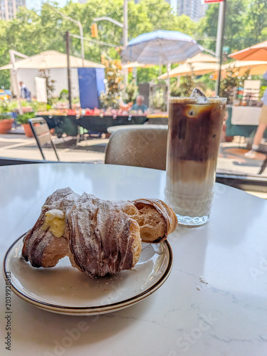 Italian Lobster tail pastry with an iced coffee at a cafe
