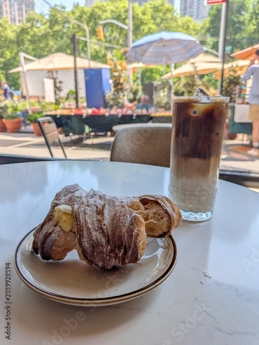 Italian Lobster tail pastry with an iced coffee at a cafe
