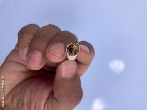 hand holding cigarette, Close up of hand holding tobacco stick