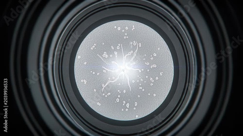 Close-up shot of glowing bacterial culture or microorganisms under microscope, view through eyepiece in biological laboratory.