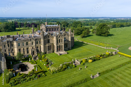 Photography Allerton Castle, North Yorkshire, England aerial view of the historic Gothic revival stately home and luxury wedding venue surrounded by gardens, woodland and Yorkshire countryside