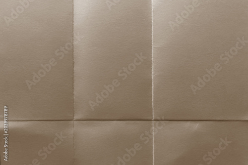 Close-up of brown folded paper with visible creases and texture.
