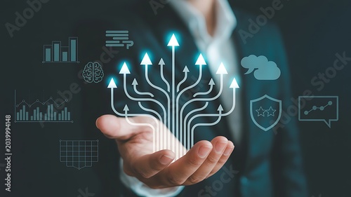 Business growth and development represented by branching arrows and abstract digital analytics icons floating above a businessman's hand