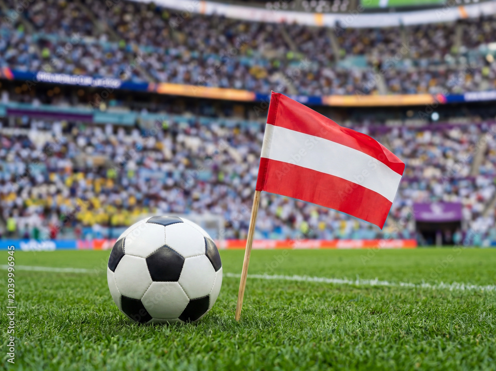 Fototapeta premium Austria flag on football field with ball