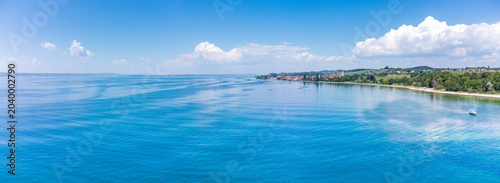 Spectacular drone panoramic perspective of the Lake Constance shoreline near Hagnau village.