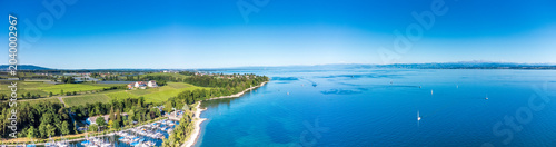 High-angle wide panorama of Lake Constance coastline with lush vineyards around Hagnau.