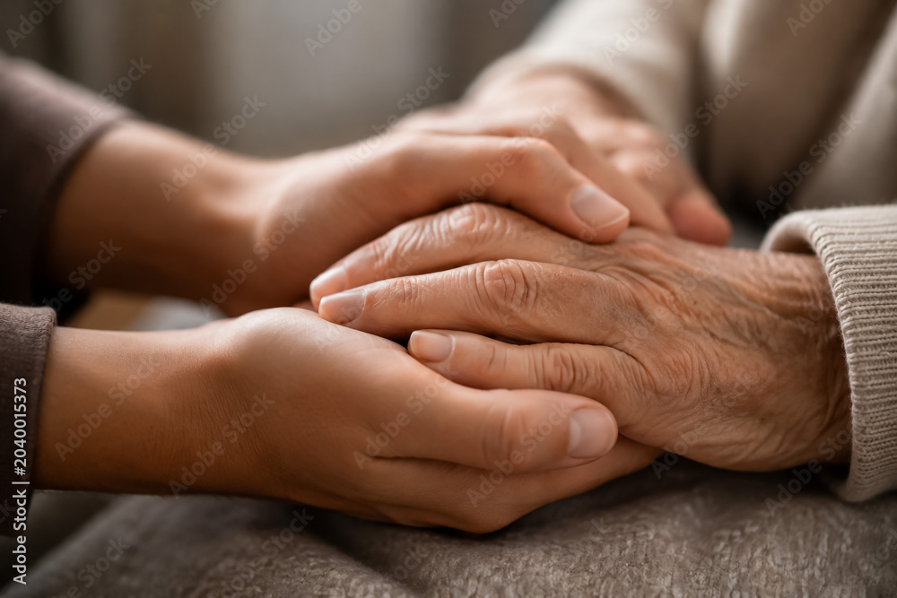 Fototapeta premium Supportive Hands Resting on a Table in a Compassionate Gesture for Connection and Care