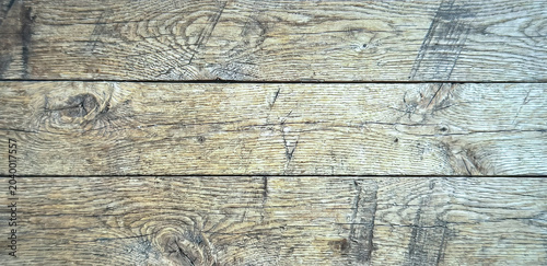 Photos Close-up of weathered wooden planks with a natural rustic texture, showcasing distinct grain patterns and small imperfections
