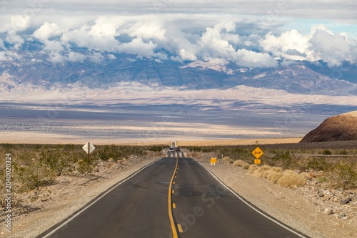 Photos Scenic desert highway descending into Death Valley under dramatic clouds
