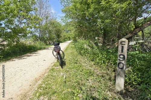 A bike stands near an old railroad mileage marker along the Heritage Trail on a sunny spring day in Dubuque County, Iowa.