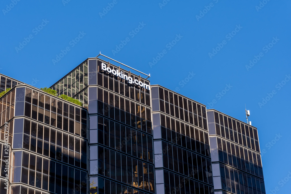 Naklejka premium Toronto, Ontario, Canada - May 30, 2026: Booking.com's Customer Call Centre building on University Ave in Toronto, Ontario, Canada. Booking.com is an online travel agency.