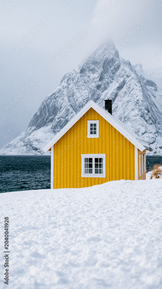 Fototapeta premium Yellow Cabin in Snowy Mountain Landscape