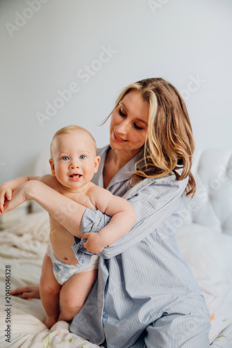 Tender mother hugging her cute blue eyed baby boy